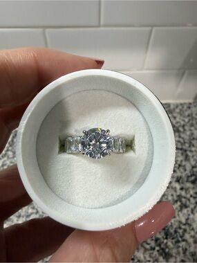 Round-Cut Silver Engagement Ring with Side Baguette Stones. Cubic Zirconia